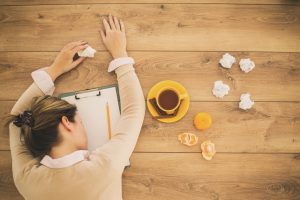 Sick woman sleeping on office desk