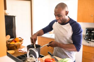 man standing happiness on the kitchen and preparing food